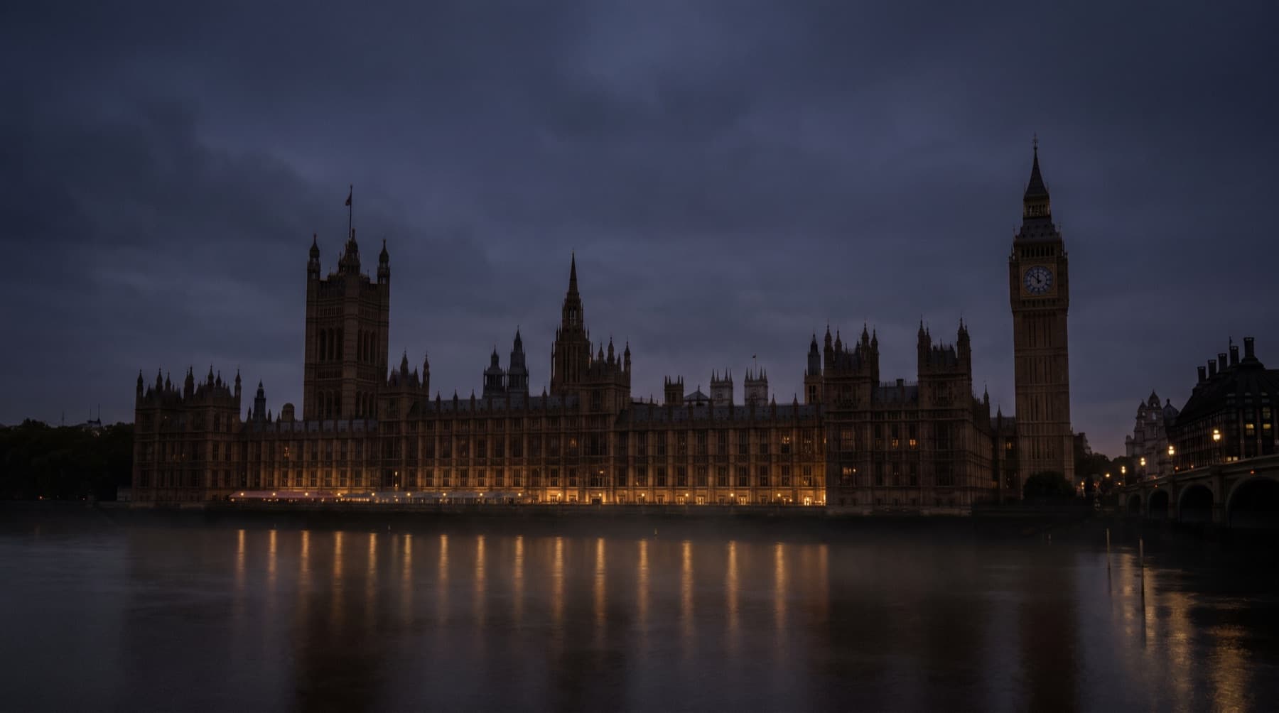 The Palace of Westminster at dusk, lit from within and reflected in the Thames